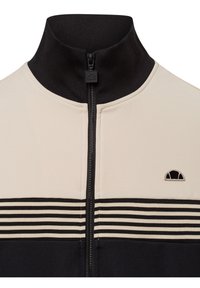 Kurtka z zamkiem błyskawicznym i wysokim kołnierzem, wykonana z kremowej i czarnej tkaniny, z poziomymi paskami i małym logo na piersi.