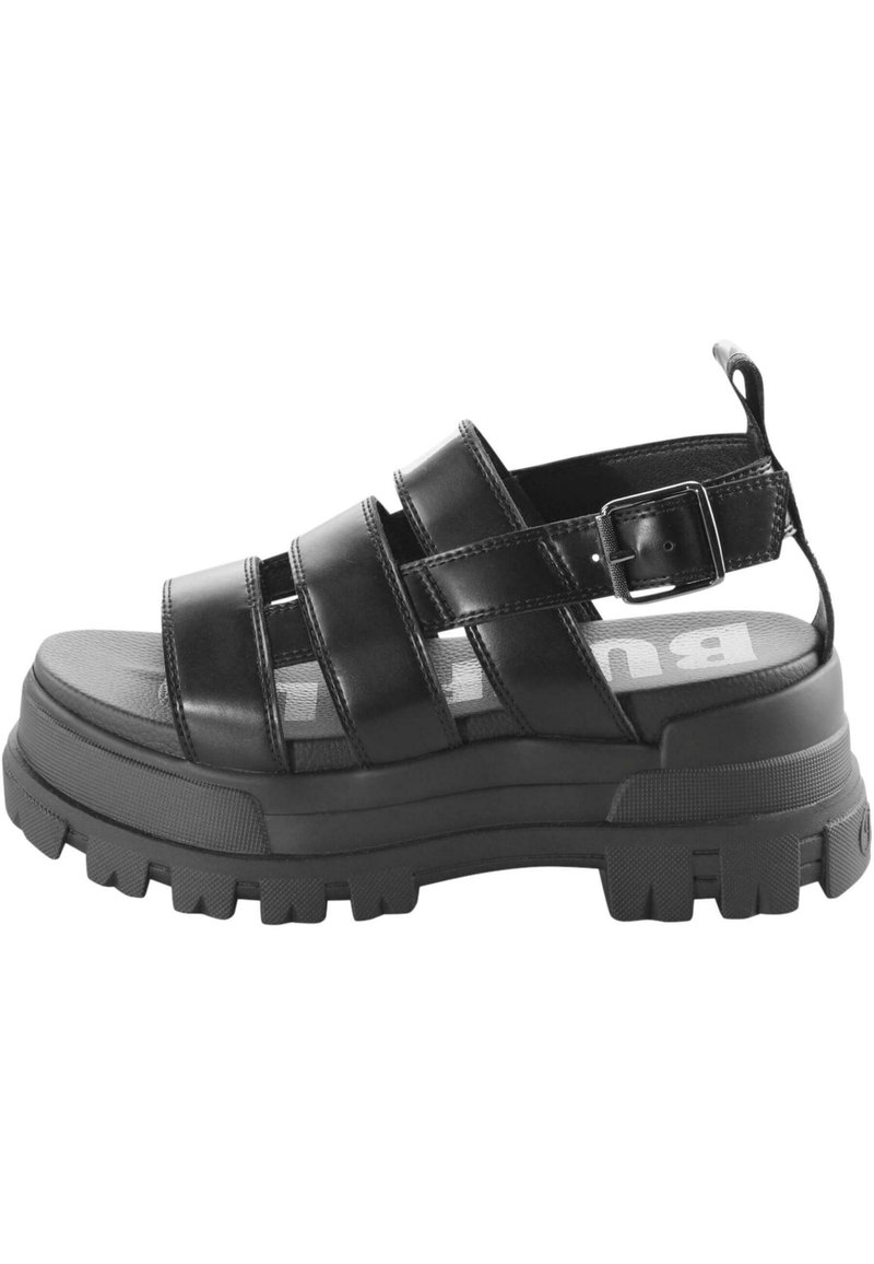 Black platform sandal made of smooth leather, featuring three wide straps, a buckle closure, and a textured rubber sole.