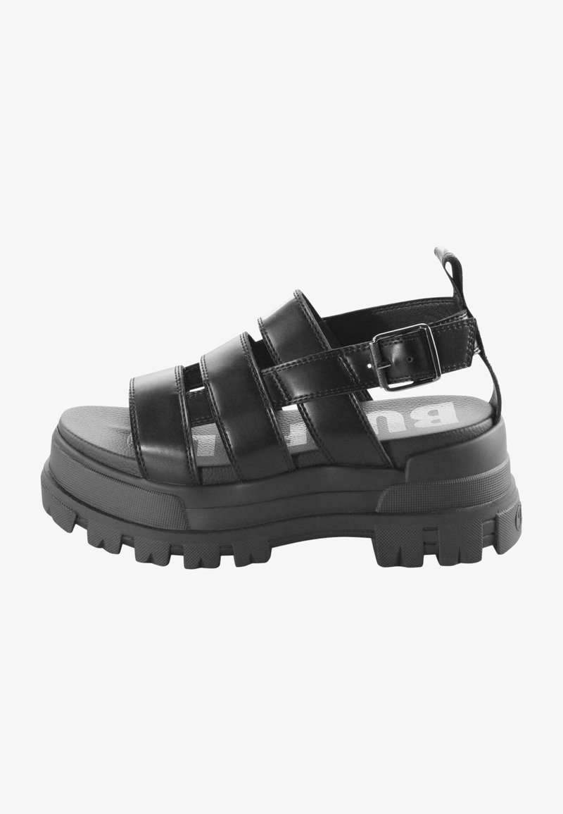Black platform sandal made of smooth leather, featuring three wide straps, a buckle closure, and a textured rubber sole.