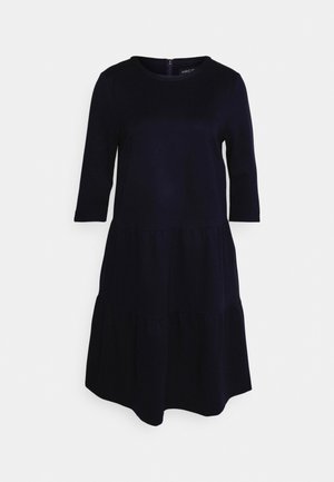 Navy blue, tiered dress with three-quarter sleeves and a round neck, featuring a back zipper. Made from a smooth, lightweight fabric.