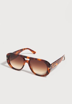 Braune Schildpatt-Sonnenbrille mit quadratischen Verlaufs-Gläsern und goldfarbenem "ALDO"-Logo am Bügel, vor hellem Hintergrund.