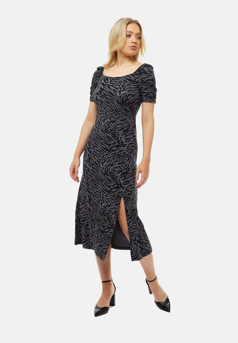 Black and grey zebra print dress with short puff sleeves, a square neckline, and a mid-length skirt featuring a side slit and fitted design.