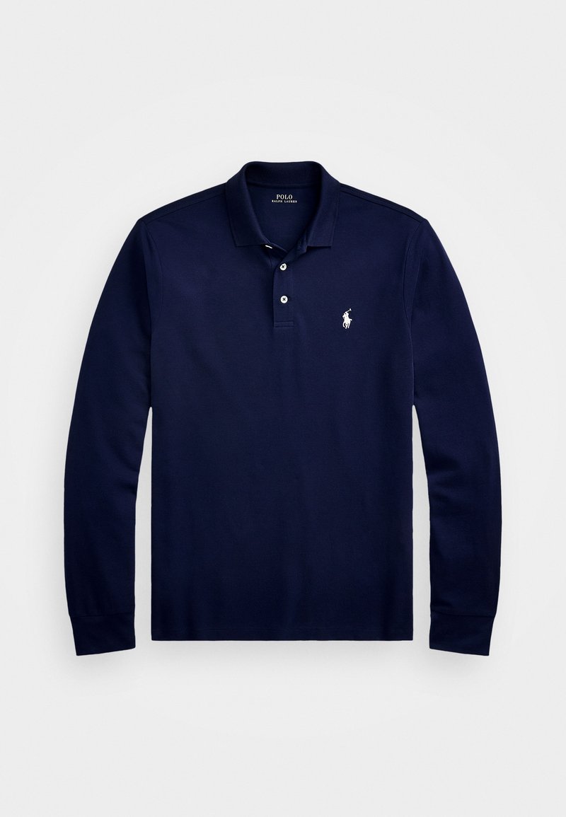 Tumesinine pika varrukaga polo-särk, mis on valmistatud puuvillast. Omab klassikalist kraed, kahe nupuga nööpide rida ja väikest tikandiga logo rinnal.