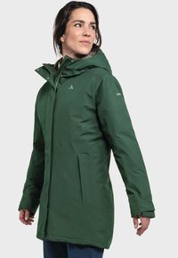 Green waterproof parka with a hood, featuring a zip closure, two front pockets, and a logo on the sleeve. Smooth texture and modern fit.