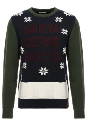 Marineblå og grøn julesweater med hvide snefnug, hvid nederste stribe og teksten "Santa Define Good" med en uglegrafik.