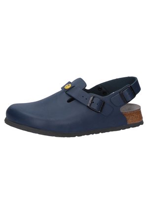 Navy blue clogs made from smooth rubber with a round toe, adjustable strap, and cork accent on the heel. Textured rubber sole for grip.