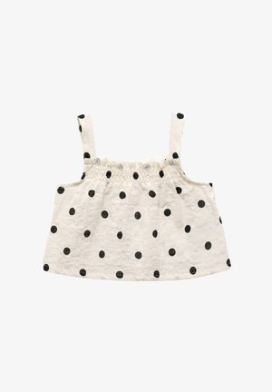 Lys cremet top med sorte prikker, der har tynde stropper og et smocket bryststykke for en afslappet pasform. Den teksturerede stof forbedrer det visuelle interesse.