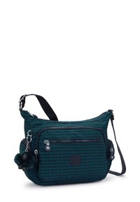 Borsa a tracolla verde scuro con un motivo geometrico, molteplici scomparti con cerniera, un charm morbido e una finitura in tessuto resistente.
