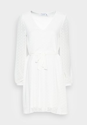 Biele šaty s v-výstrihom, dlhými priesvitnými rukávmi a opaskom na viazanie. Textúra látky s bodkovaným vzorom, splývavá sukňa a elastické manžety.