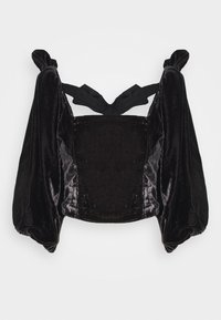 Svart sammet croppad topp med puffärmar och knytning bak. Mjuk textur och glans; har en strukturerad byst och breda manschetter.