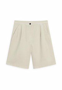 Housut vaaleanruskeat, litteällä vyötärömyksellä, yksittäisellä napilla suljettuna, etuhelmoilla ja kahdella sivutaskulla. Liukas pinta ja polvenpituinen malli.