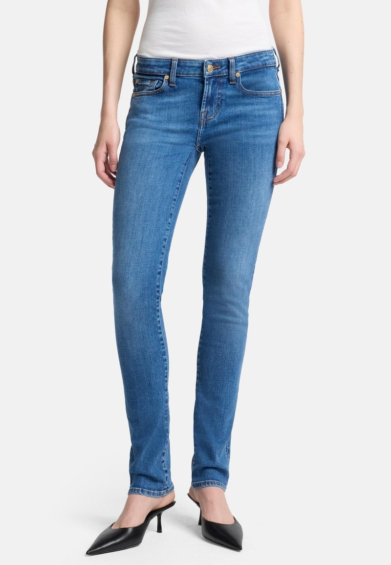 Blauwe denim skinny jeans met een gladde textuur, klassiek vijf-pocket ontwerp en contrasterende stiksels bij de naden.