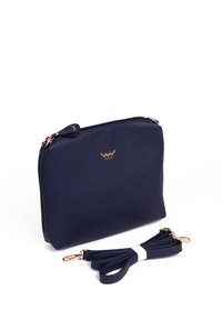 Navy blue synthetic leather handbag with a gold logo, zip closure, and detachable rose gold hardware strap. Smooth texture, rectangular shape.