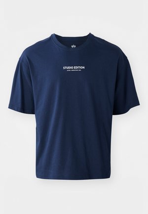 Navy blue short-sleeve T-shirt made of cotton, featuring a round neckline and white text reading "STUDIO EDITION" on the front.