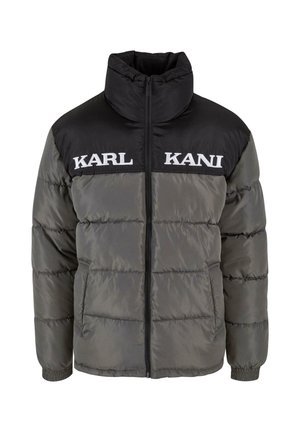 Puffer jacket with a black upper section and gray lower section, featuring a high collar, zip closure, and "KARL KANI" logo in white.