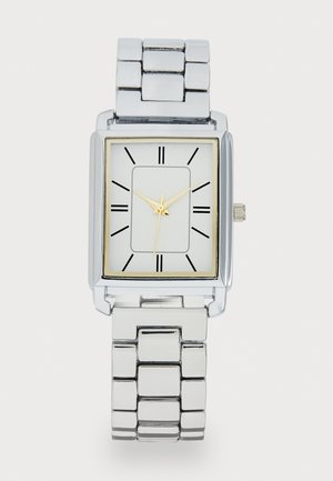 Silver rectangular watch with a polished metal band, white face, gold hour and minute hands, black hour markers, and gold trim around the face.