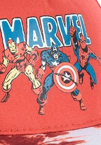 Red cap featuring Marvel characters Iron Man, Captain America, and Spider-Man in bold colors. Graphic print with a textured fabric finish.