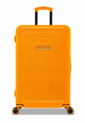 Hard-shell suitcase in bright orange. Features vertical ribbed texture, black handle, and wheels. "SUITSUIT" logo on the front.