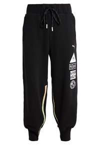 Zwarte joggingsbroek met een elastische tailleband en koord. Bevat zijpatronen in pastelkleuren en grafische prints op de voorkant.