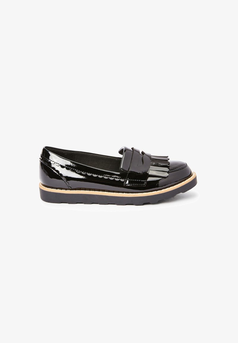Black patent leather loafers with a decorative fringed strap, flat sole, and scalloped detailing along the top edge.