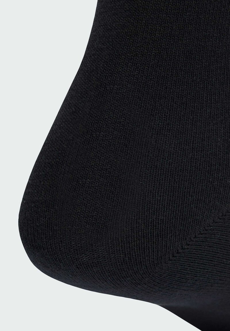 Black sock with a textured, ribbed design. Features a smooth toe and reinforced heel for added durability.