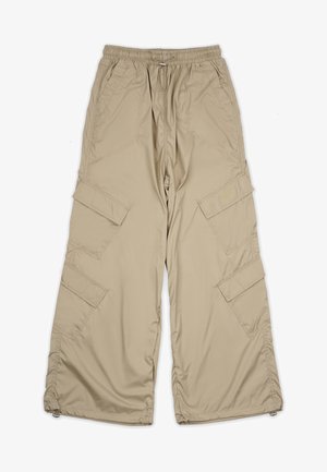 Beige cargo pants with a drawstring waist, multiple side pockets, and a relaxed fit. Made of lightweight, smooth fabric with stitching details.