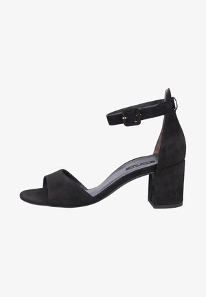 Black suede heeled sandal with an open toe and ankle strap. Features a block heel and smooth footbed, designed for comfort and stability.