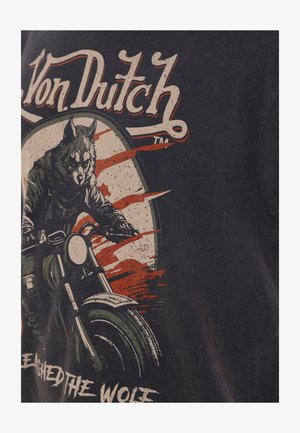 Camiseta gráfica negra con un jinete lobo montando una motocicleta, con detalles desgastados en rojo y blanco y el texto "Von Dutch" arriba.