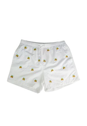 Costumi da bagno bianchi con cintura elastica e cordoncino, caratterizzati da ricami di frutta gialla sparsi con foglie verdi.