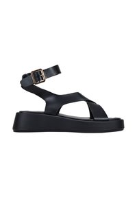 Black platform sandal featuring adjustable ankle strap, crossover straps, smooth leather material, and a chunky, textured sole.