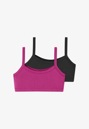 Zwei nahtlose Bralettes aus weicher Baumwollmischung mit dünnen Trägern, ein magentafarbenes vor einem schwarzen liegend auf weißem Hintergrund.