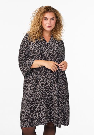 Leopard print dress featuring a v-neckline, three-quarter sleeves, and a tiered skirt design. Soft fabric with a flowing silhouette.