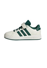 White low-top Adidas sneaker with green stripes, green laces, green inner lining, and a single white Velcro strap on a white background.