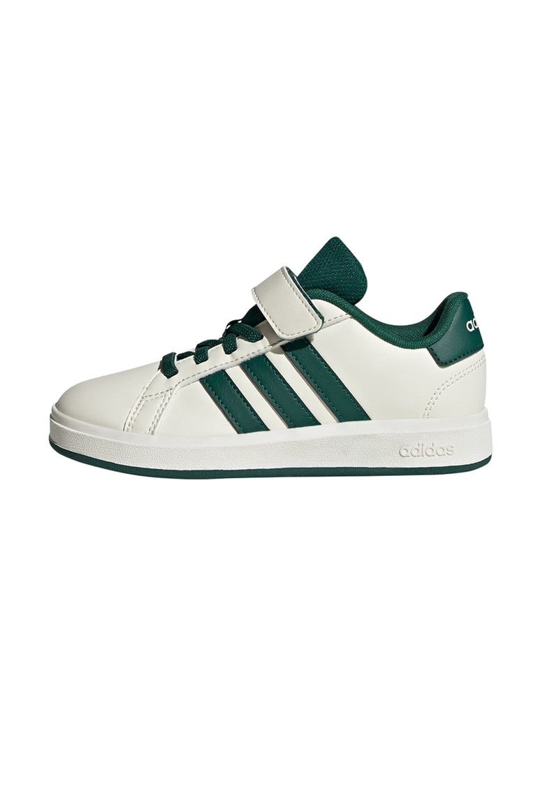 White low-top Adidas sneaker with green stripes, green laces, green inner lining, and a single white Velcro strap on a white background.