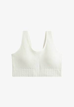 Ribbad vit bralette med breda remmar och texturerad band. Har en rundad halsringning och en figurnära design för stöd och komfort.