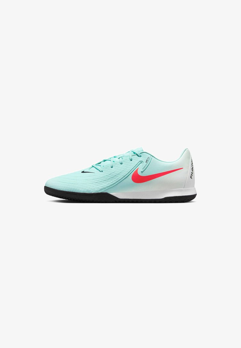 Mint green athletic shoe with a textured surface, red Nike swoosh accent, black sole, and lightweight design. Laces and padded collar.
