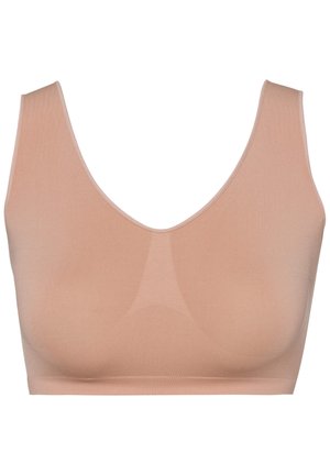 Seamless bra in light beige, made from smooth fabric. Features a deep V-neck design and wide straps for support. No visible hardware.