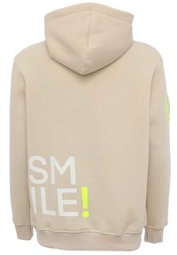Beige hoodie with a drawstring hood. Front features large white text reading "SMILE!" with a bright yellow accent. Soft fabric texture.