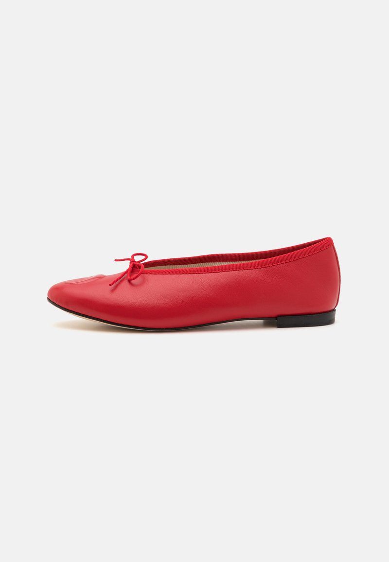 Red leather ballet flats with a rounded toe, featuring a small bow detail at the front, and a flexible black rubber sole.