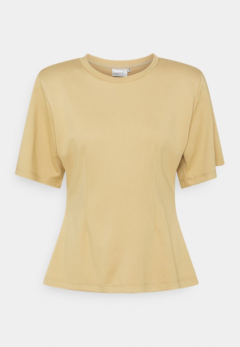 T-shirt beige à manches courtes avec un col rond et un ourlet légèrement évasé. Fabriqué en tissu lisse et léger avec un léger éclat.