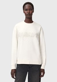 Biała bluza z napisem "ALLSAINTS" wykonanym z błyszczących zdobień, okrągły dekolt, długie rękawy, teksturowany materiał oraz ściągacze przy mankietach i u dołu.