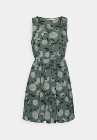 Vihreä ilmanhihaista mekkoa, jossa on valkoisia kukkia ja mustia lehtikuvioita, kapea vyötärö ja liehuva hameosa. Valmistettu pehmeästä kankaasta, sileä rakenne.