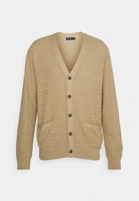 Beige cardigan i strukturerat stickat tyg, med V-hals, sex knappar, två framfickor och en liten logotyp på bröstet.