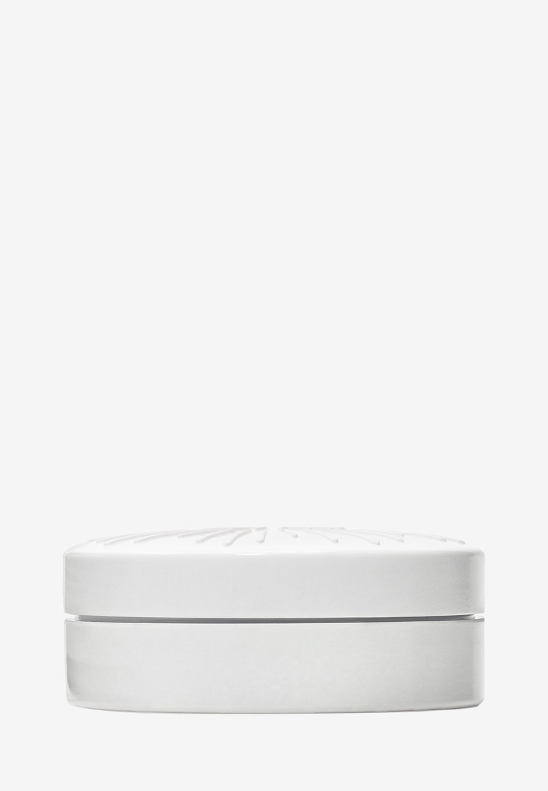 Round white container with a slightly raised lid featuring subtle linear patterns, shown from a side view on a plain background.