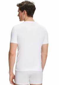White short-sleeve t-shirt made of smooth fabric, fitted design, and a crew neckline, viewed from the back.