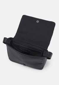 Czarna skórzana torba z zamknięciem na magnes. Wnętrze posiada małą kieszeń i gładką fakturę. Minimalistyczny design.