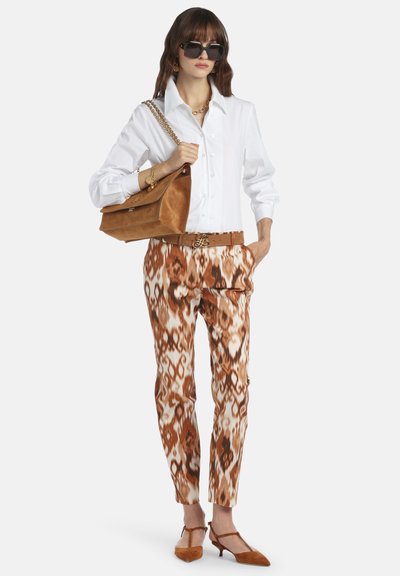 White button-up shirt, brown patterned pants, brown suede bag, and matching shoes with a strap, featuring gold-tone hardware accents.