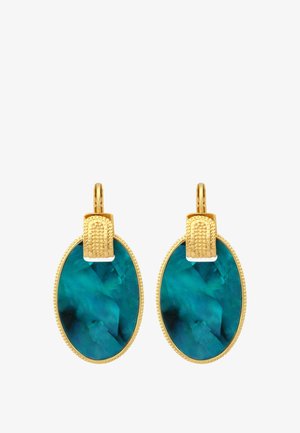 Boucles d'oreilles en or avec de grandes pierres précieuses ovales bleu-vert et crochets en or texturés, présentées sur un fond blanc.