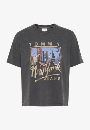 Cotton graphic t-shirt in dark gray with a boxy fit. Features a NYC skyline print in blue and gold accents. Crew neck and short sleeves.