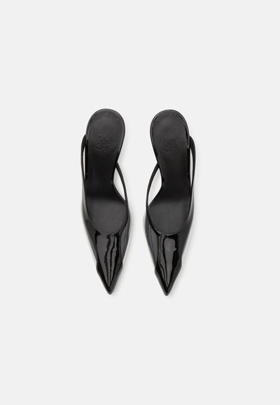 Black patent leather slingback heels with a pointed toe, slender ankle strap, and smooth texture. No visible hardware or patterns.